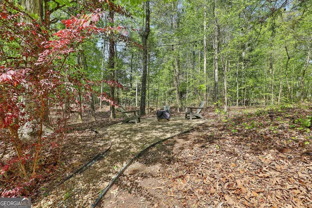 a view of a house with swimming pool and sitting area