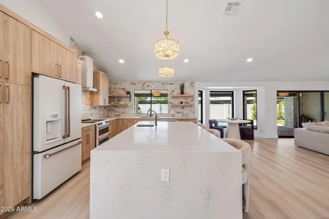 a large kitchen with a table and chairs