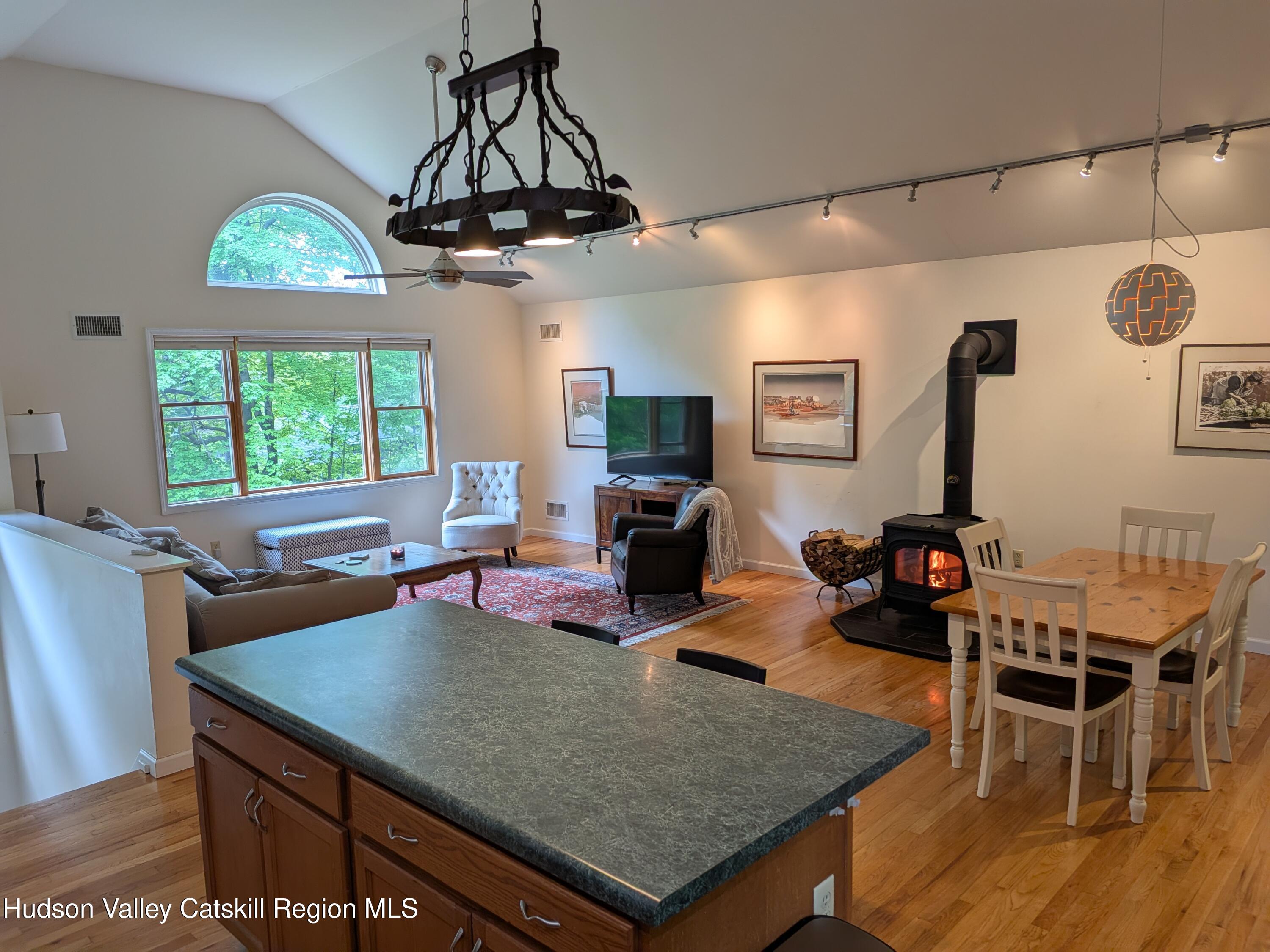 513 South Mountain Road Gardiner, NY 12525 - Photo 8 of 63 a view of a dining room with furniture a chandelier and wooden floor
