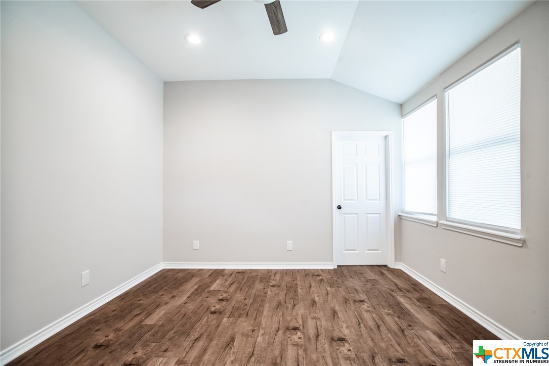 801-803 South Main Street Victoria, TX 77901 - Photo 3 of 11 an empty room with wooden floor and windows
