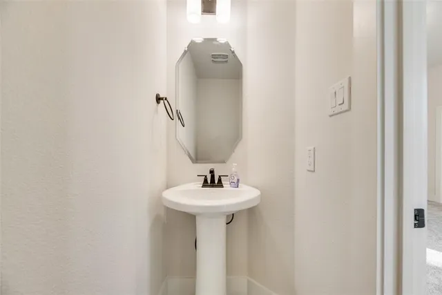a bathroom with a sink and mirror