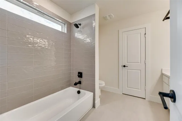 a bathroom with a bathtub and shower