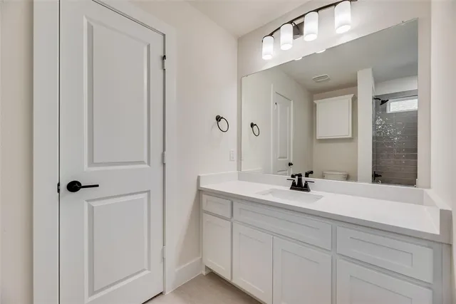 a bathroom with a double vanity sink and mirror