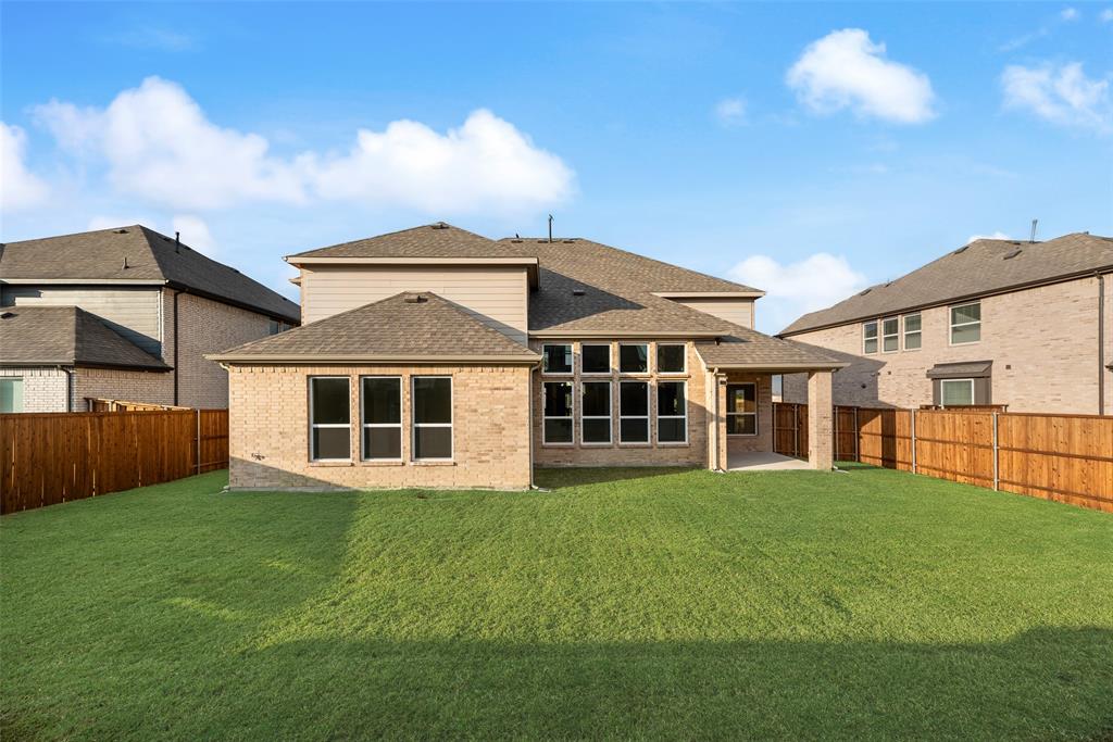 1055 Modesto Drive Frisco, TX 75036 - Photo 29 of 29 a view of a yard in front of a house with large windows