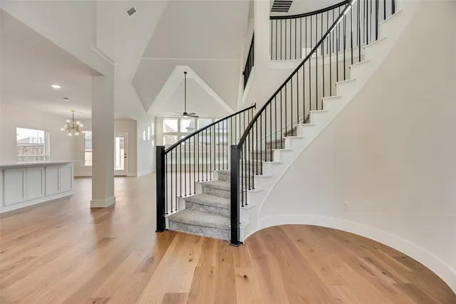 a view of staircase with wooden floor and a rug
