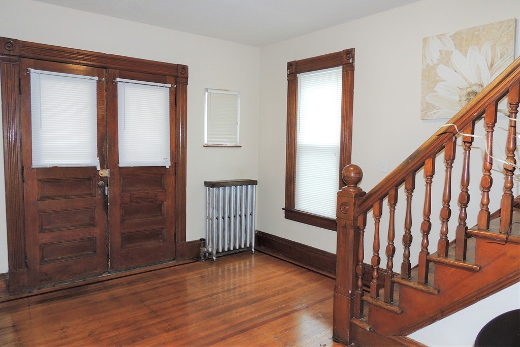 73 Crystal Avenue Springfield, MA 01108 - Photo 15 of 30 a view of a hallway with wooden floor and stairs