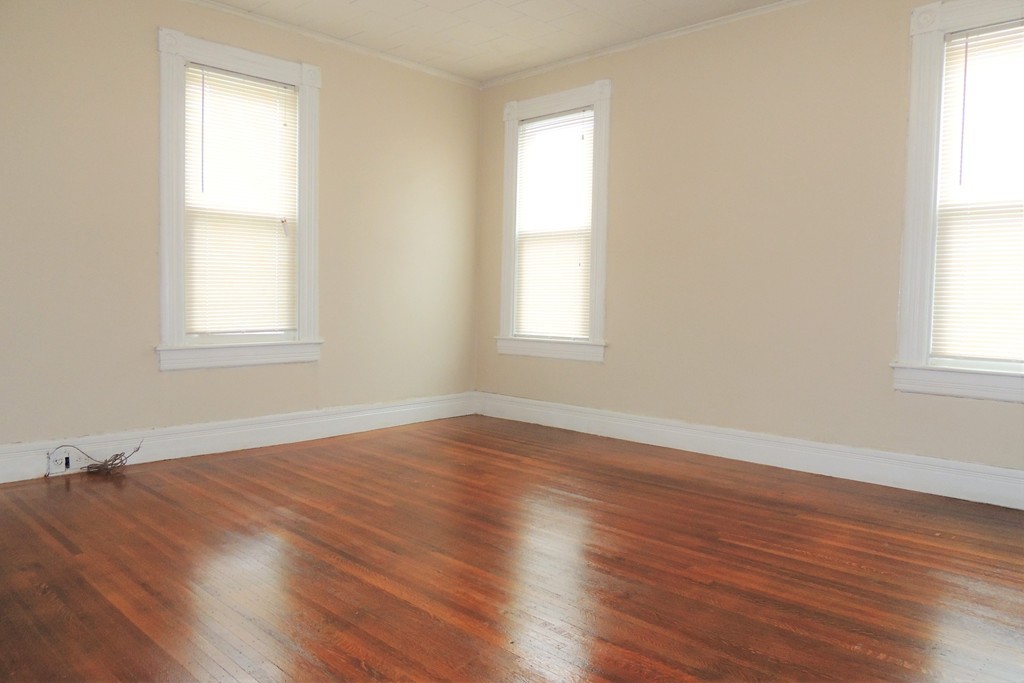 73 Crystal Avenue Springfield, MA 01108 - Photo 18 of 30 an empty room with wooden floor and windows