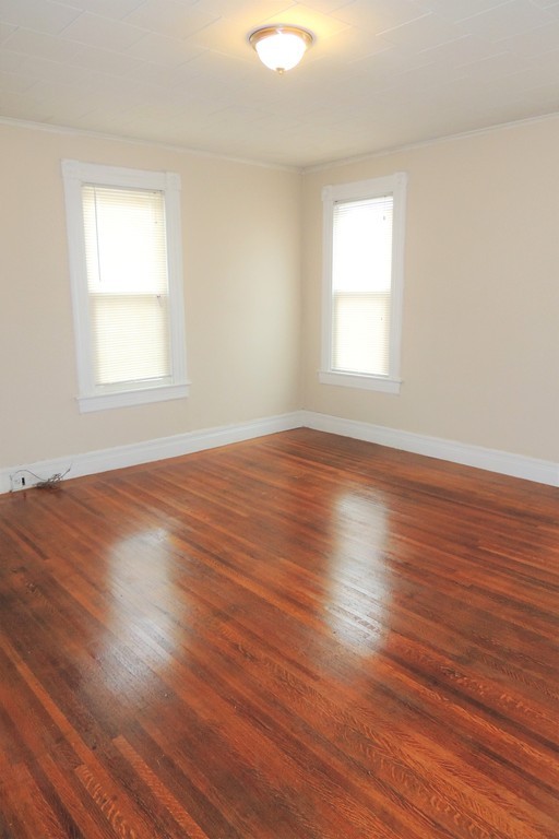 73 Crystal Avenue Springfield, MA 01108 - Photo 19 of 30 an empty room with wooden floor and windows