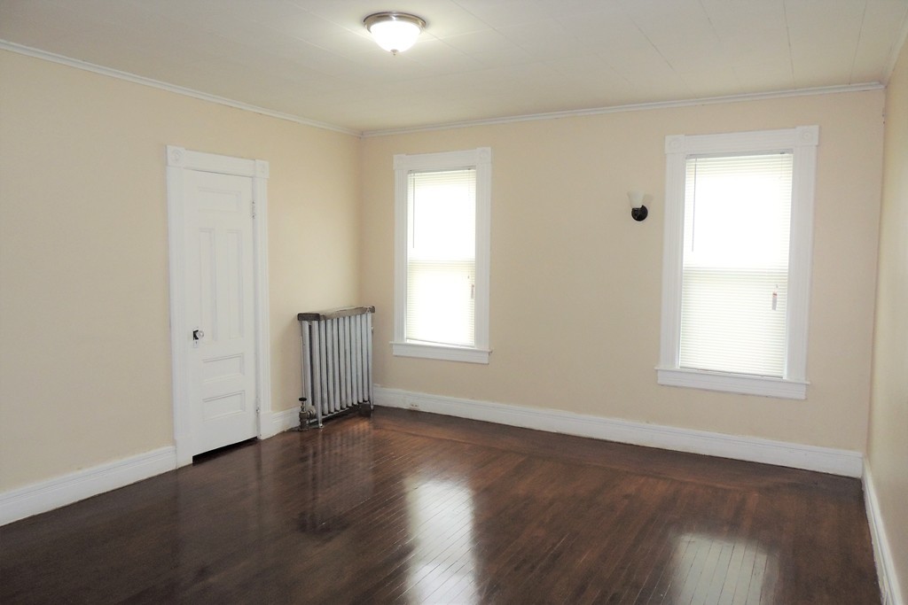 73 Crystal Avenue Springfield, MA 01108 - Photo 20 of 30 an empty room with wooden floor and windows