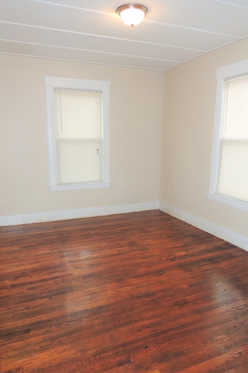 73 Crystal Avenue Springfield, MA 01108 - Photo 26 of 30 an empty room with wooden floor and windows