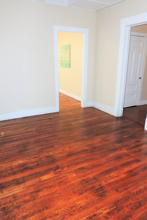 73 Crystal Avenue Springfield, MA 01108 - Photo 27 of 30 a view of an empty room with wooden floor and a window
