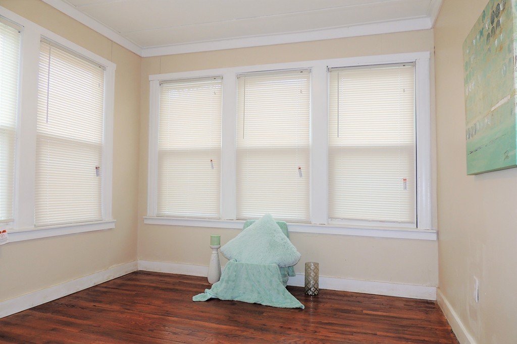 73 Crystal Avenue Springfield, MA 01108 - Photo 28 of 30 an empty room with wooden floor and windows