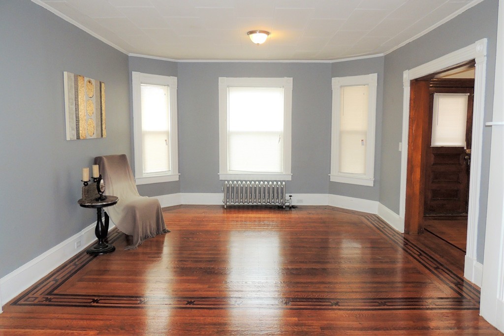 73 Crystal Avenue Springfield, MA 01108 - Photo 4 of 30 a view of empty room with wooden floor and fan
