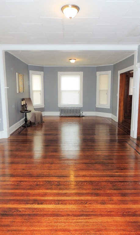 73 Crystal Avenue Springfield, MA 01108 - Photo 5 of 30 a view of empty room with wooden floor and window