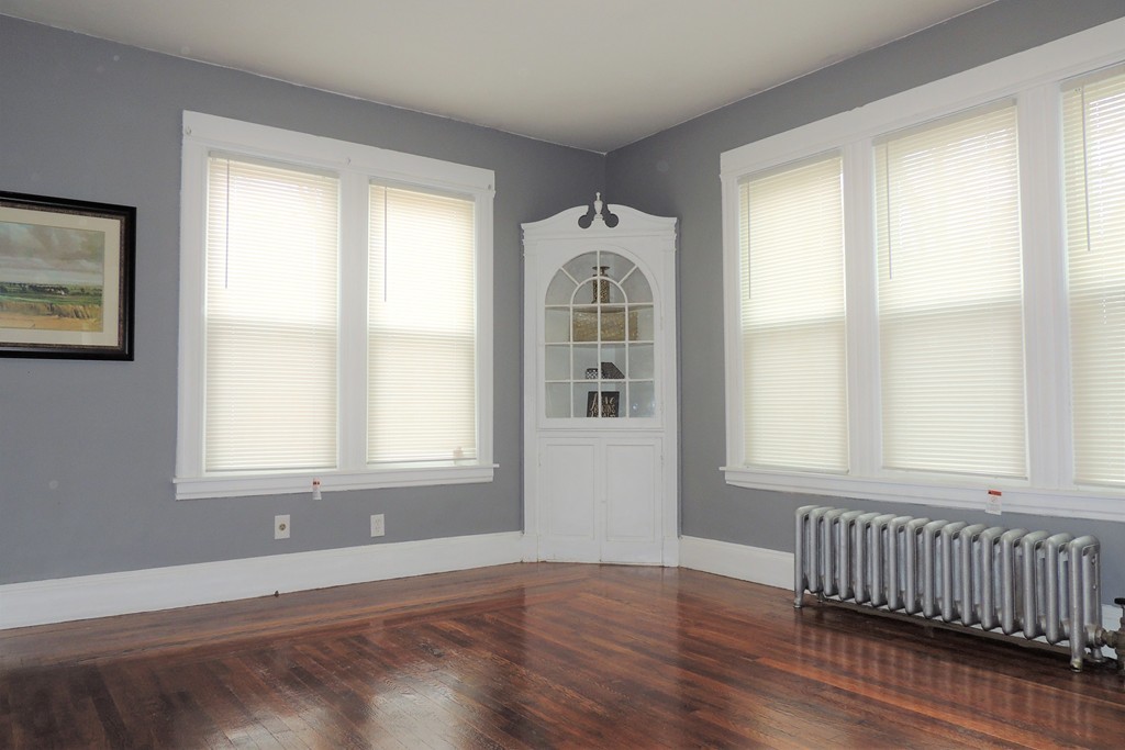 73 Crystal Avenue Springfield, MA 01108 - Photo 8 of 30 a view of an empty room with wooden floor and a window