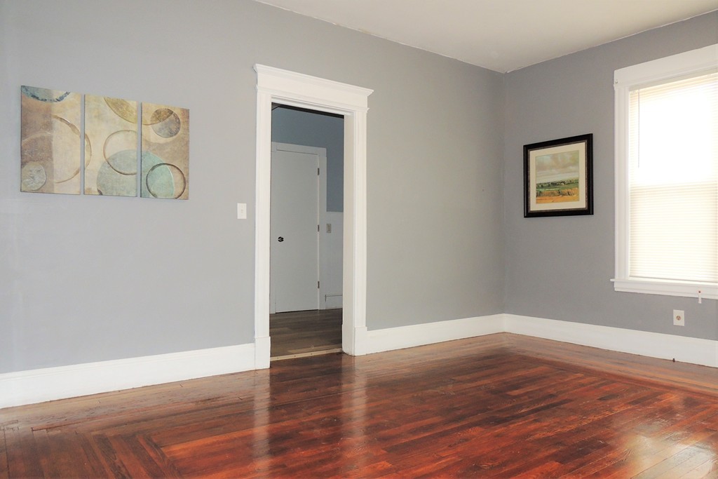 73 Crystal Avenue Springfield, MA 01108 - Photo 9 of 30 a view of an empty room with wooden floor and a window