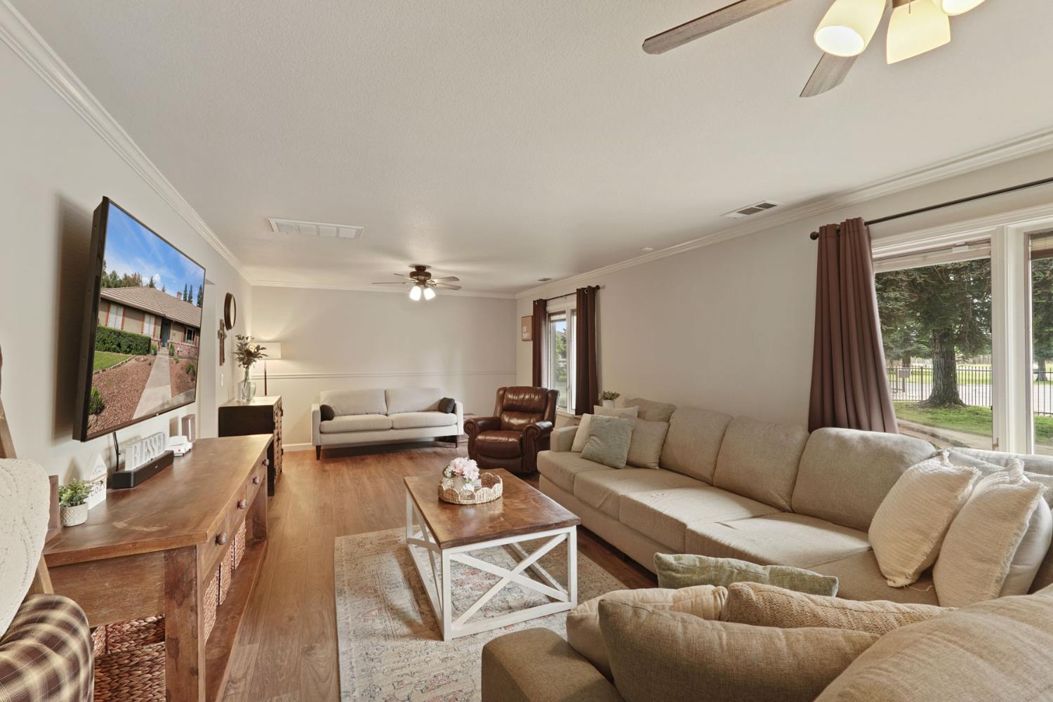 12963 Spring Time Lane Galt, CA 95632 - Photo 12 of 49 a living room with furniture and a flat screen tv
