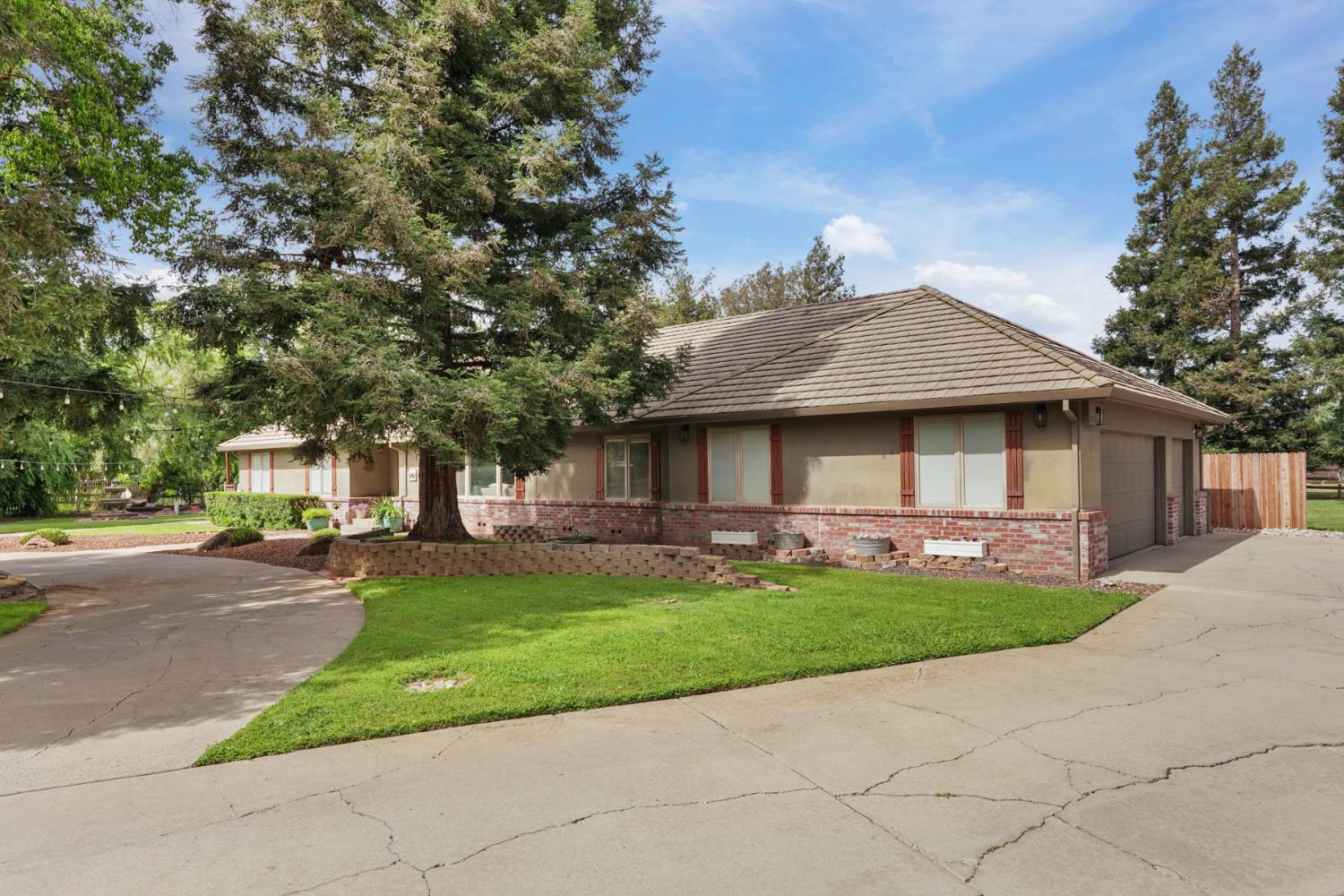 12963 Spring Time Lane Galt, CA 95632 - Photo 2 of 49 a front view of house with yard space and tree