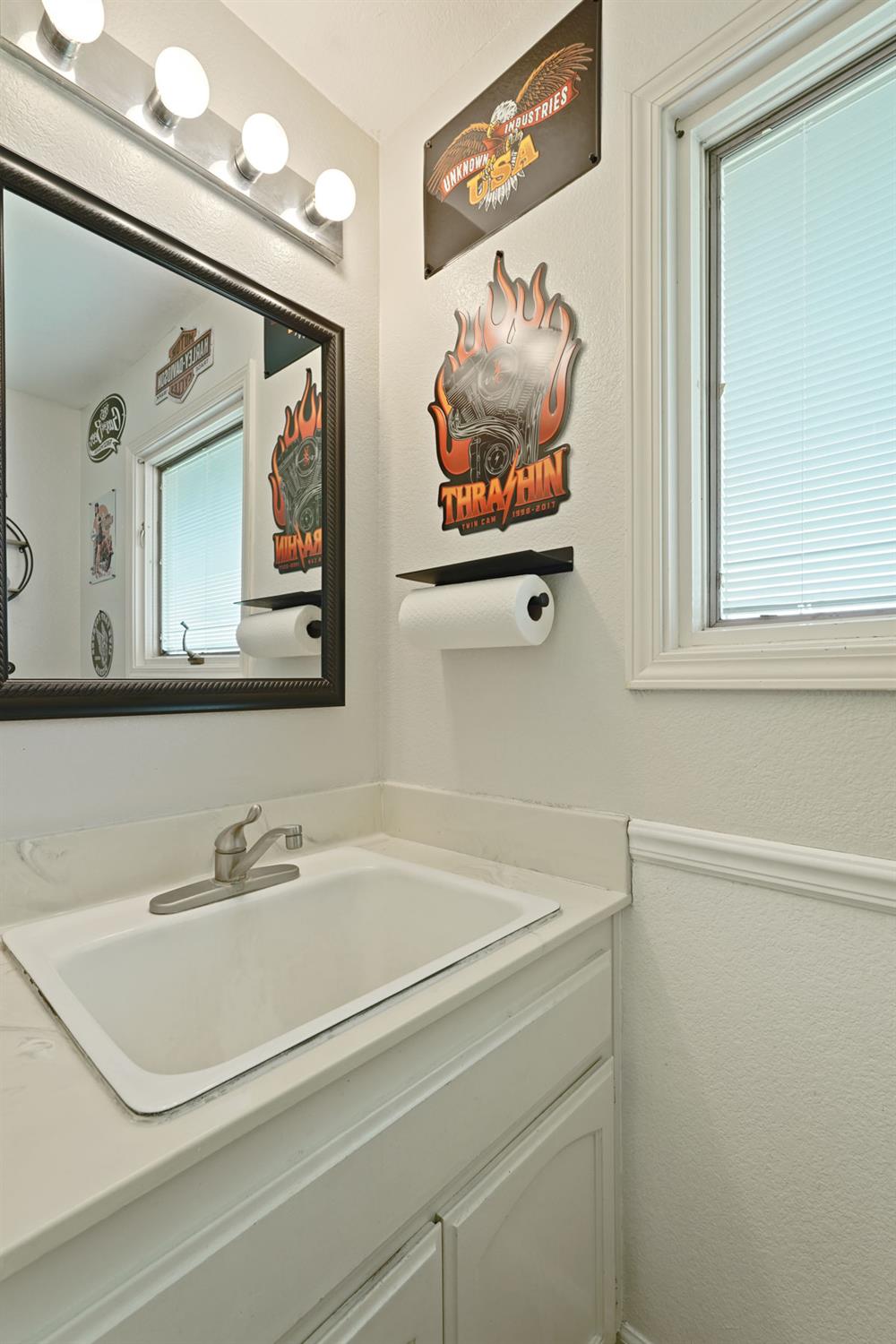 12963 Spring Time Lane Galt, CA 95632 - Photo 23 of 49 a bathroom with a sink mirror and vanity