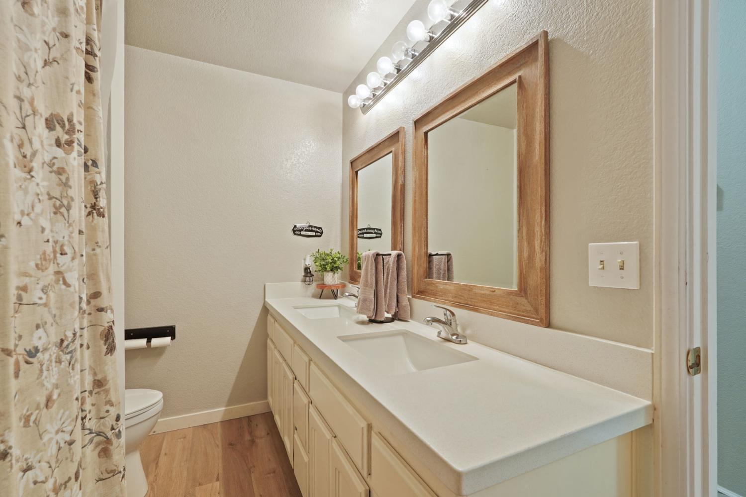 12963 Spring Time Lane Galt, CA 95632 - Photo 24 of 49 a bathroom with a sink a toilet a mirror and shower