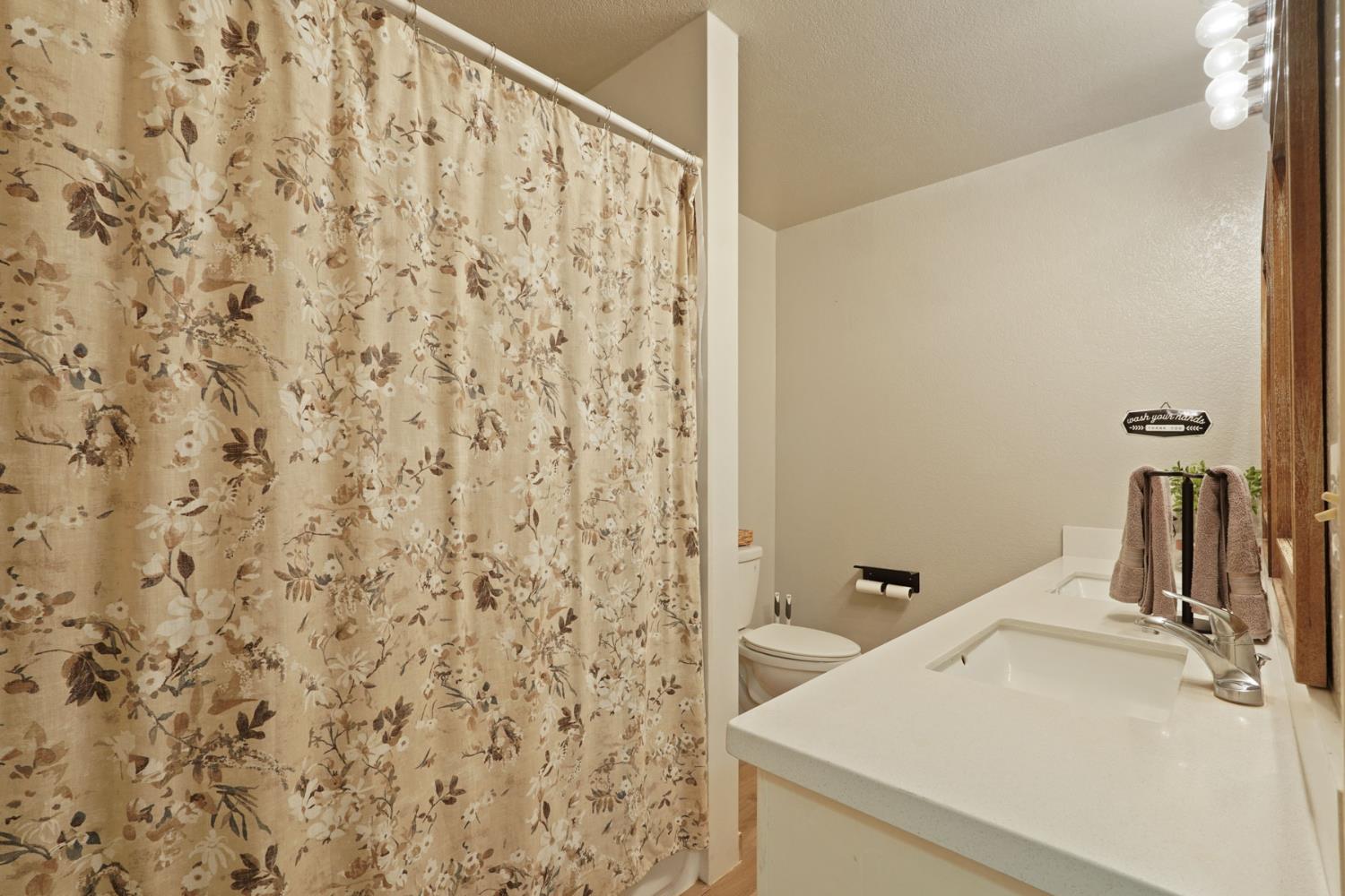 12963 Spring Time Lane Galt, CA 95632 - Photo 25 of 49 a bathroom with a sink and a mirror