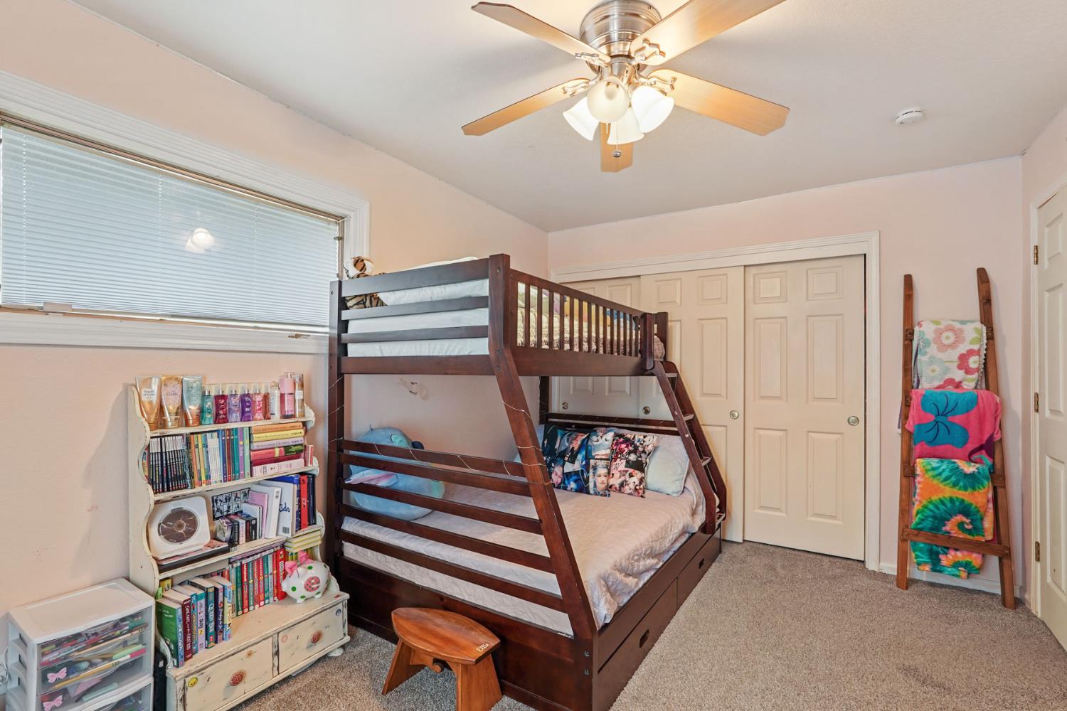 12963 Spring Time Lane Galt, CA 95632 - Photo 29 of 49 a bedroom with a bed and a chandelier