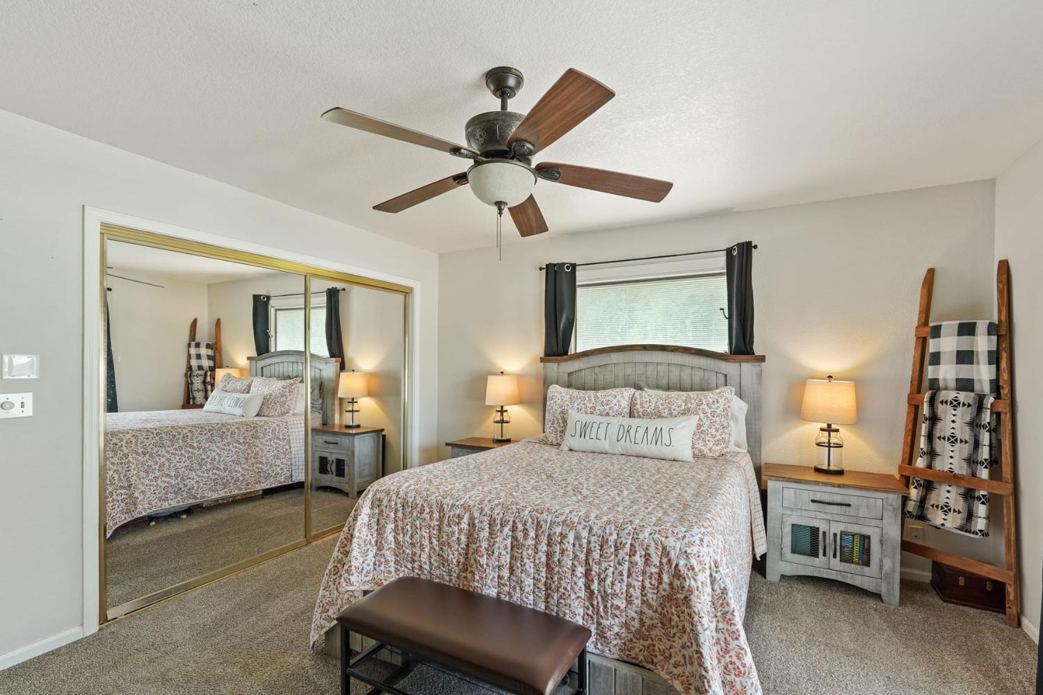 12963 Spring Time Lane Galt, CA 95632 - Photo 31 of 49 a bedroom with a bed and a chandelier fan
