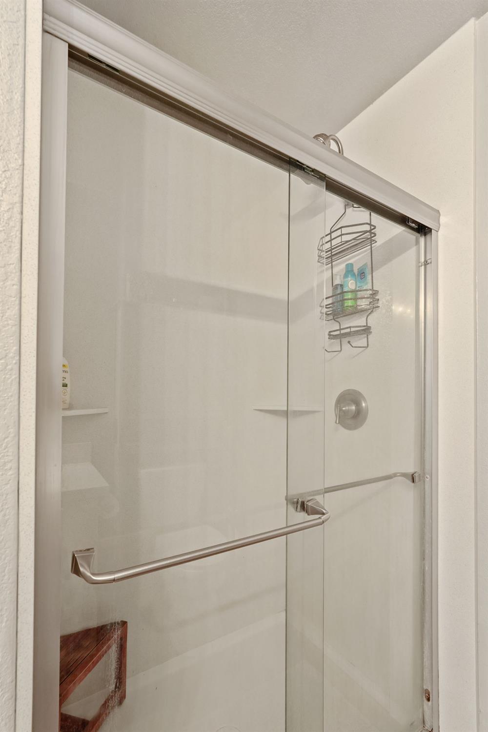 12963 Spring Time Lane Galt, CA 95632 - Photo 34 of 49 a bathroom with a glass shower door