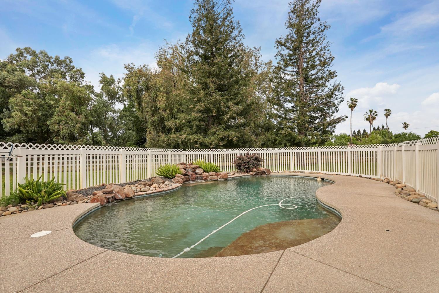 12963 Spring Time Lane Galt, CA 95632 - Photo 35 of 49 a view of a backyard with wooden fence