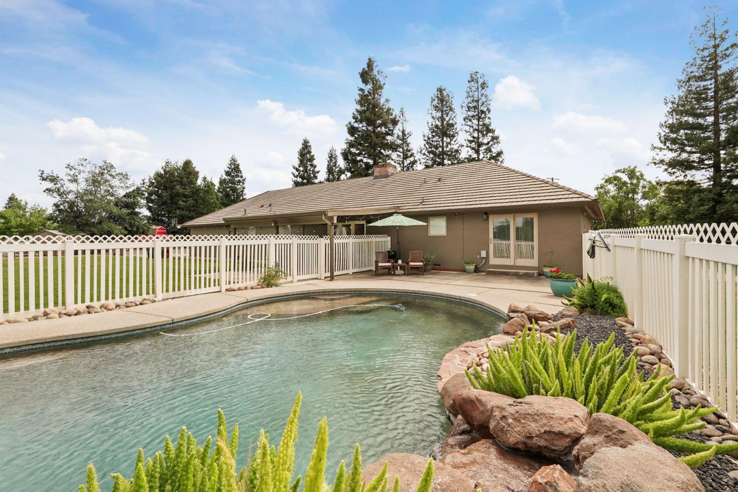 12963 Spring Time Lane Galt, CA 95632 - Photo 36 of 49 a view of a house with swimming pool and sitting area