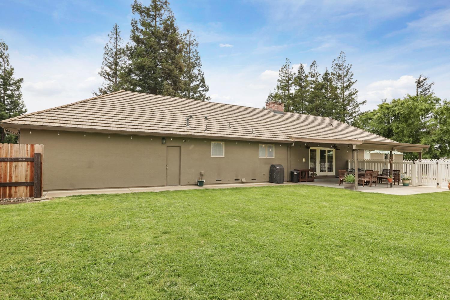 12963 Spring Time Lane Galt, CA 95632 - Photo 40 of 49 a front view of a house with a garden and trees
