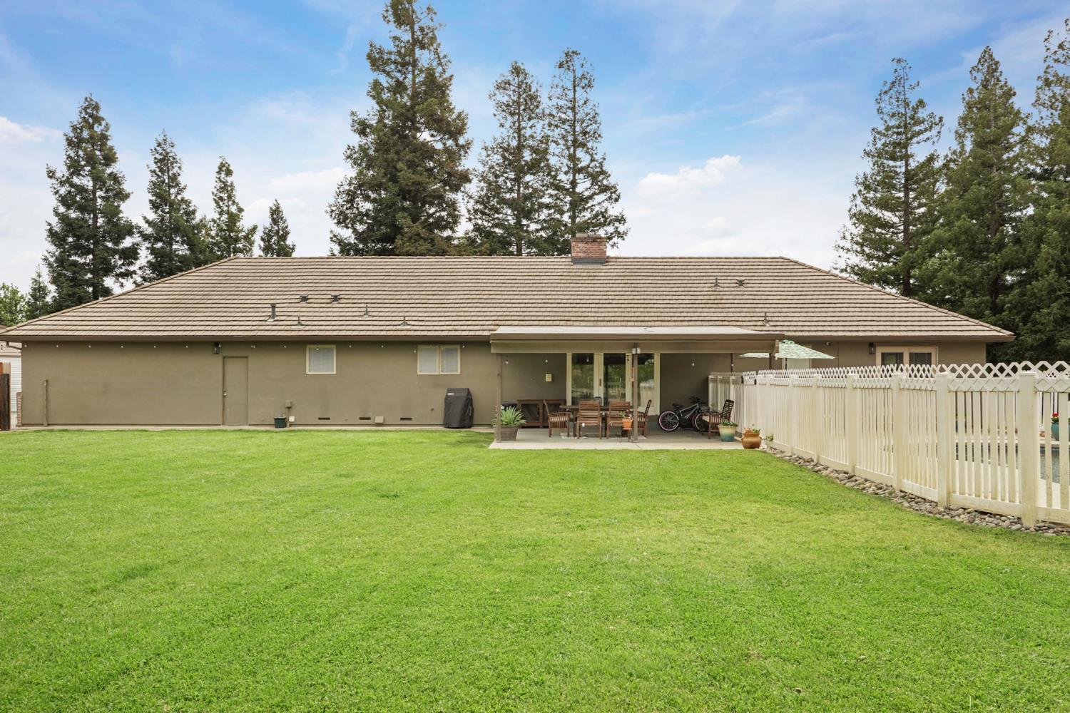 12963 Spring Time Lane Galt, CA 95632 - Photo 41 of 49 a view of a house with a garden and yard
