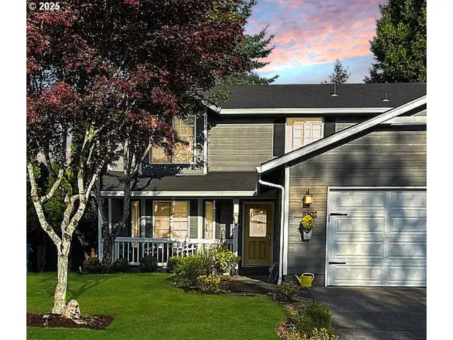 a front view of a house with a garden