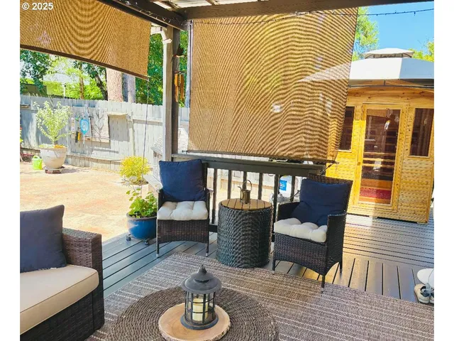 a view of a patio with couches chairs and wooden floor