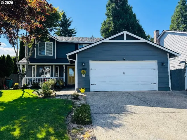 a view of a house with a yard patio and a small yard