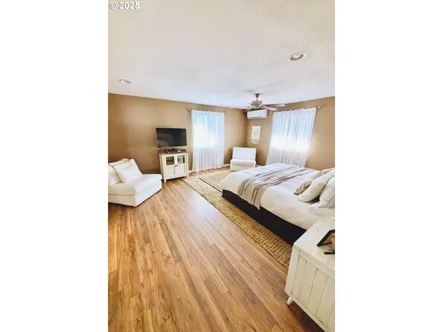 a bedroom with a bed and a mirror