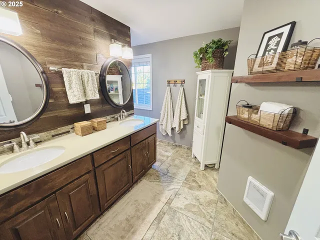 a bathroom with a double vanity sink and a mirror