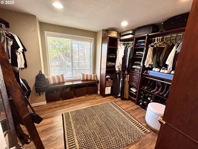 a bedroom with furniture and a rug
