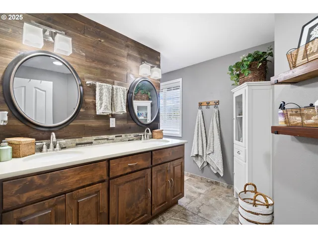 a bathroom with a double vanity sink and a mirror