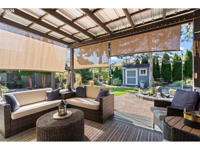 a outdoor space with patio the couches and a fireplace with the potted plants