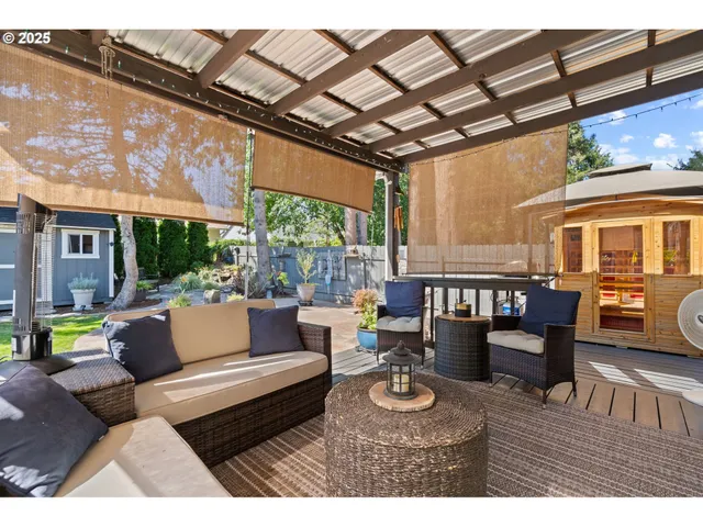 a outdoor living space with furniture and a black umbrella