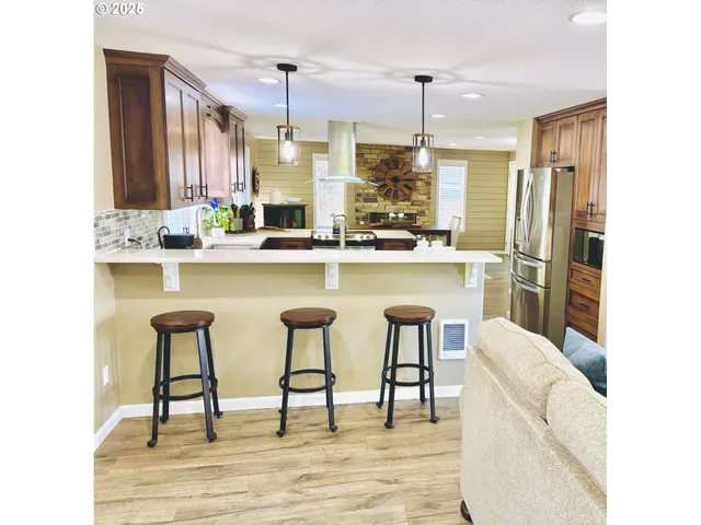 a kitchen with a table chairs refrigerator and microwave
