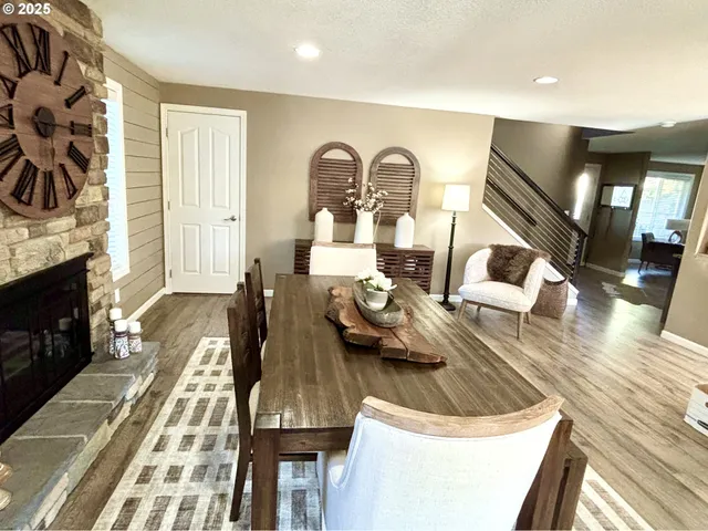 a living room with furniture fireplace and wooden floor