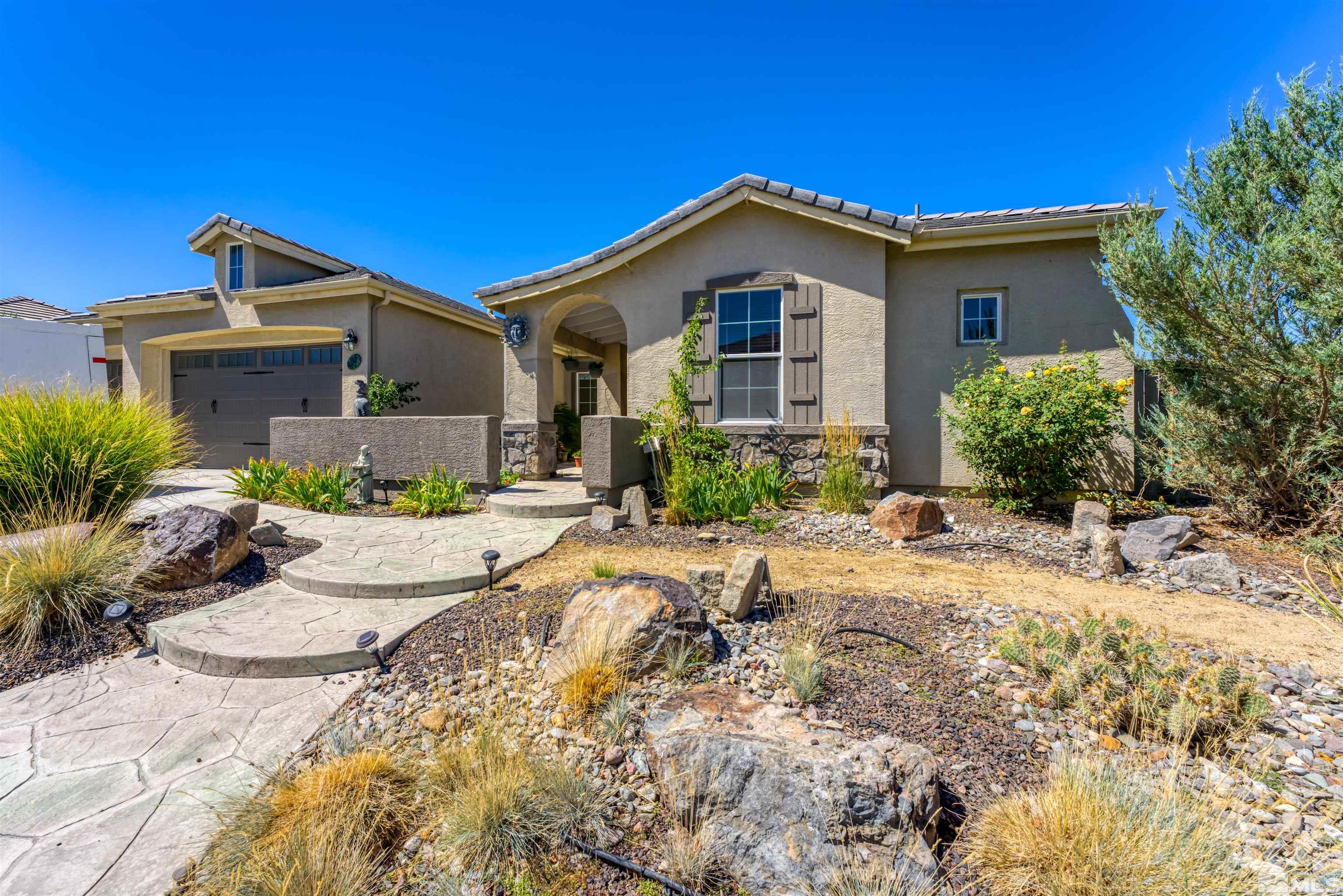 10555 Dillingham Drive Reno, NV 89521 - Photo 1 of 34 a front view of a house with a yard