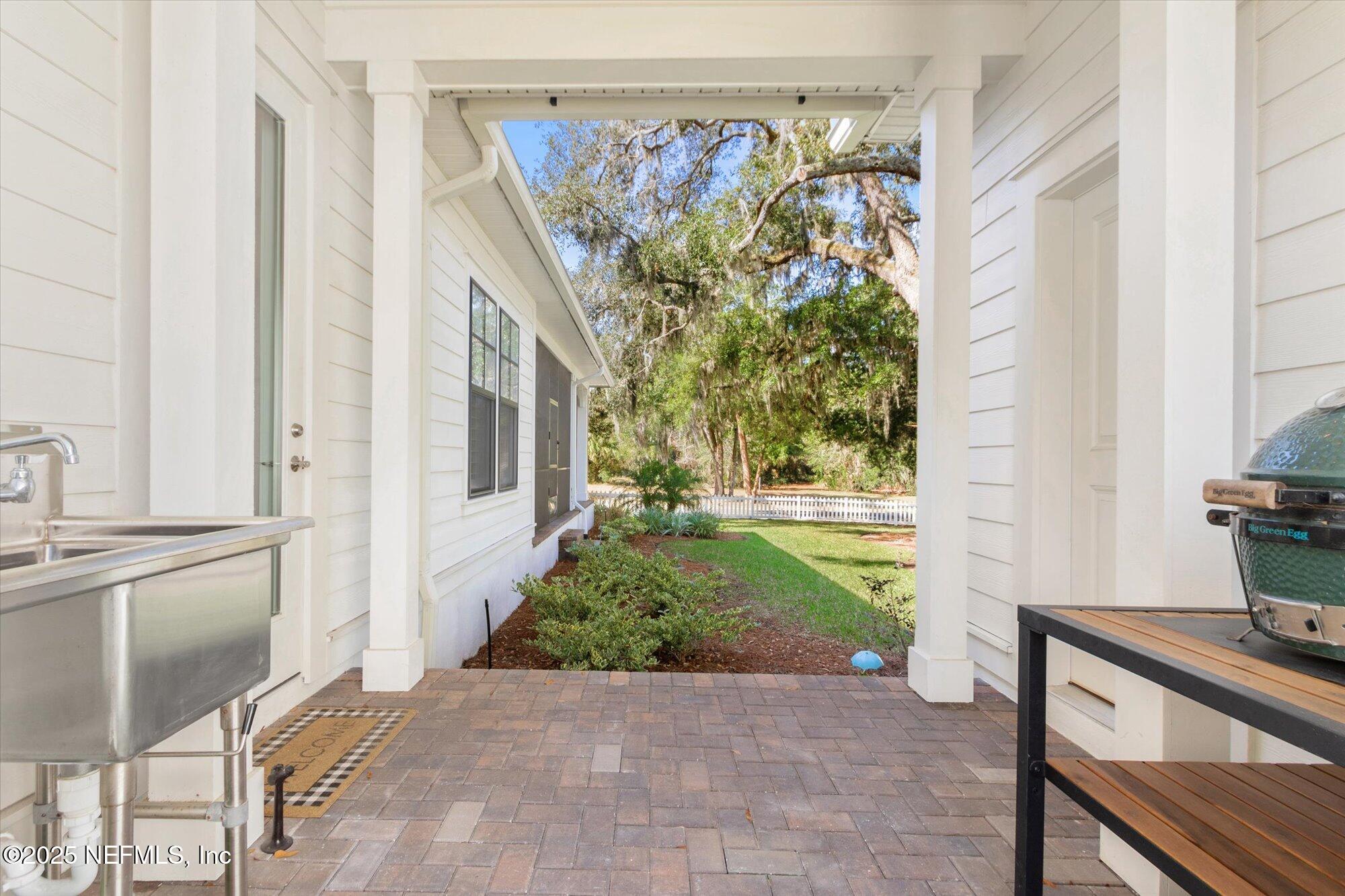28341 Grandview Manor Yulee, FL 32097 - Photo 36 of 64 a view of a porch with chairs and a potted plant