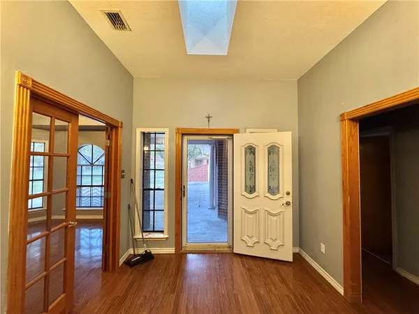 a view of an entryway with wooden floor