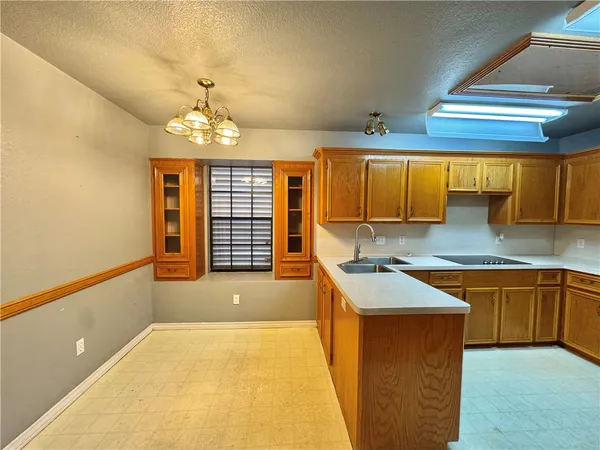 a kitchen with stainless steel appliances granite countertop a sink and a stove