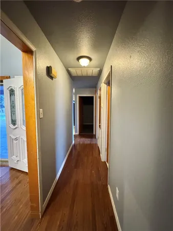 a view of hallway with wooden floor