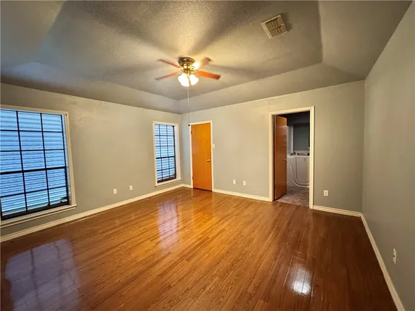 wooden floor in an empty room with a window