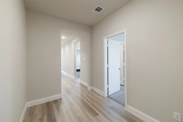 a view of hallway with wooden floor